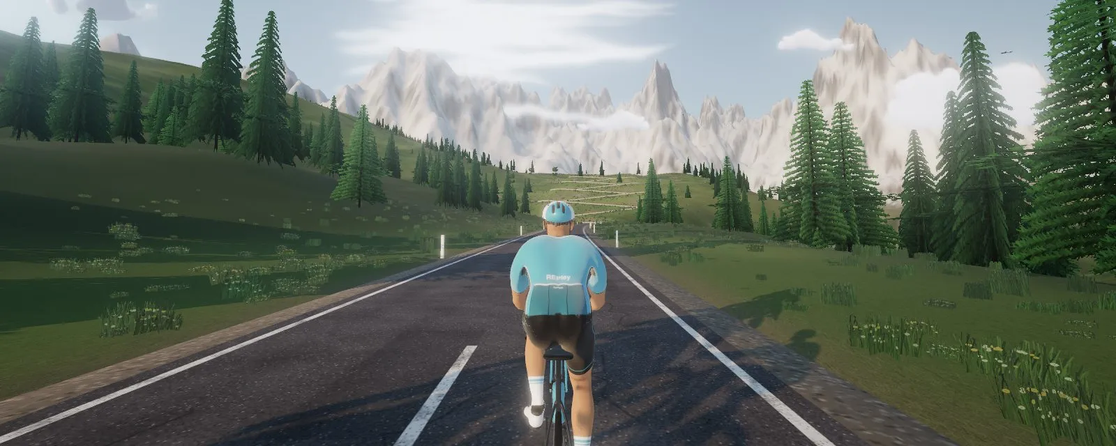 A rider heading up an alpine climb in REPley Ride, the indoor cycling app free for a coach's clients